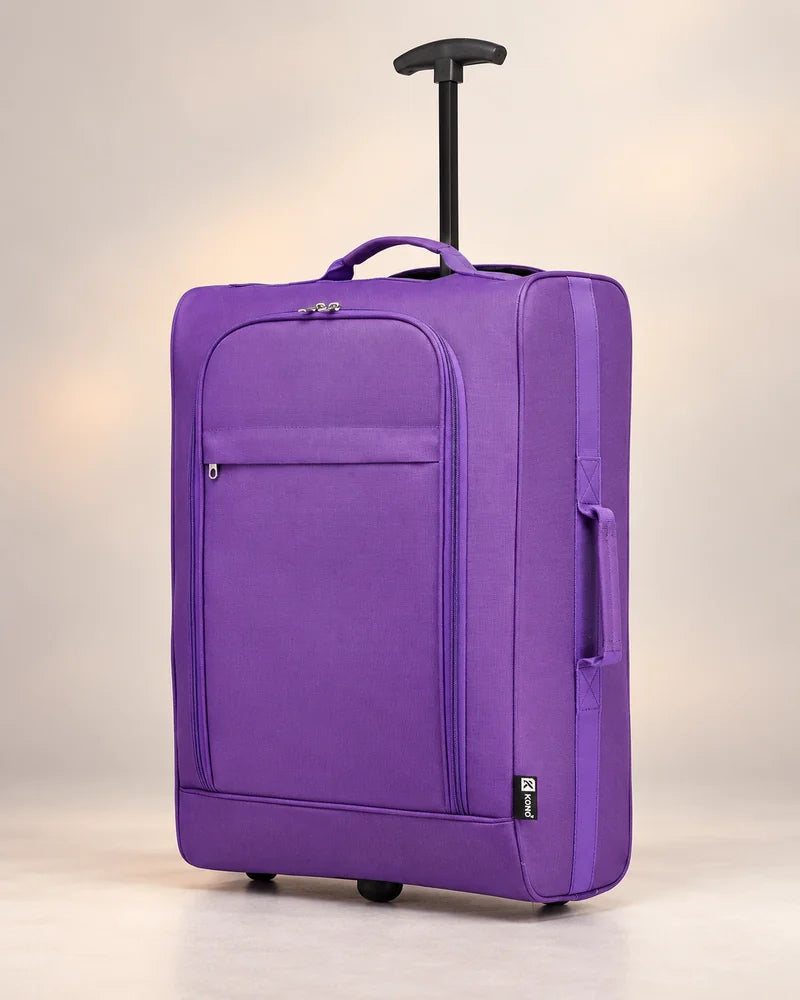Purple soft-sided suitcase with a single-stem trolley handle against a warm neutral background.
