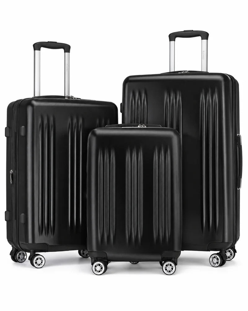 Three black rolling suitcases with silver wheel faces on a white background.