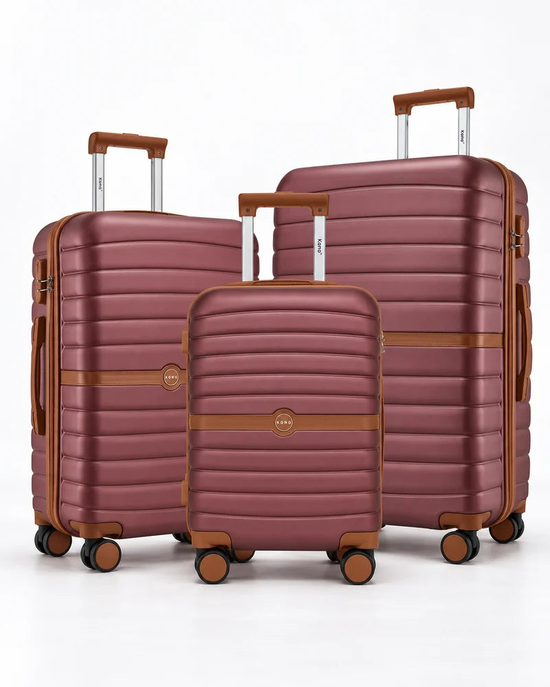 Three burgundy and brown rolling suitcases on a white background.